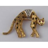 A 9 carat gold brooch designed as a cat and set with rubies, sapphires and diamonds, approx 4cm, 4.