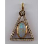 A yellow metal (tests 14 carat gold) opal and diamond triangular pendant,