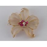 A carved chalcedony floral design brooch of fine quality, with 18 carat gold mount,