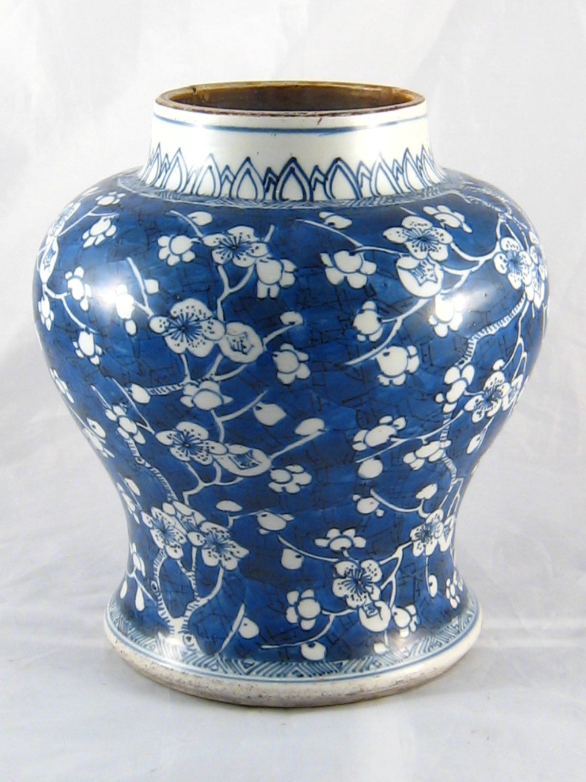 A Chinese squat baluster vase, circa 1700, with prunus on cracked ice. Repair to rim. 20cm. across.