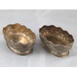 A pair of Victorian silver oval bowls on spread bases, embossed with stiff acanthus, swags and bows,