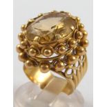 A yellow metal (tests 18 carat gold) citrine ring, citrine approx. 18 x 14mm, ring size M, 12.7 gms.