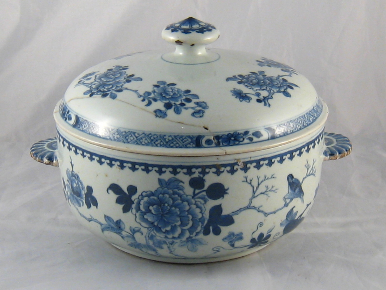 A Chinese round tureen and cover, circa 1770, decorated with flowers and birds, Repair to cover.