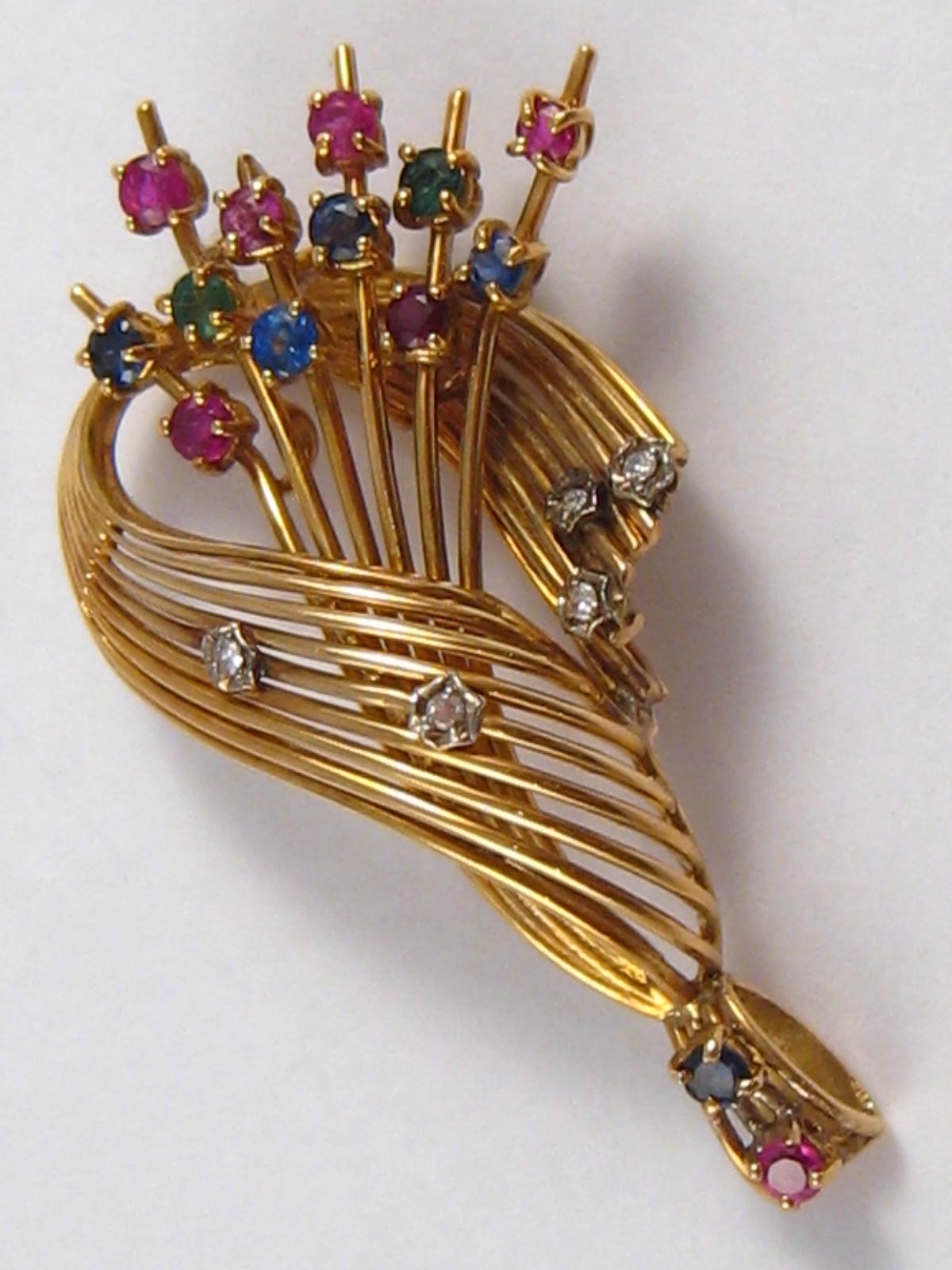 A yellow metal (tests 18 carat gold) ruby, sapphire, emerald and diamond pendant, approx 5cm, 9.