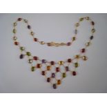 A yellow metal (tests 14 carat gold) multi gem “tutti frutti” fringe necklace, approx 38cm long,