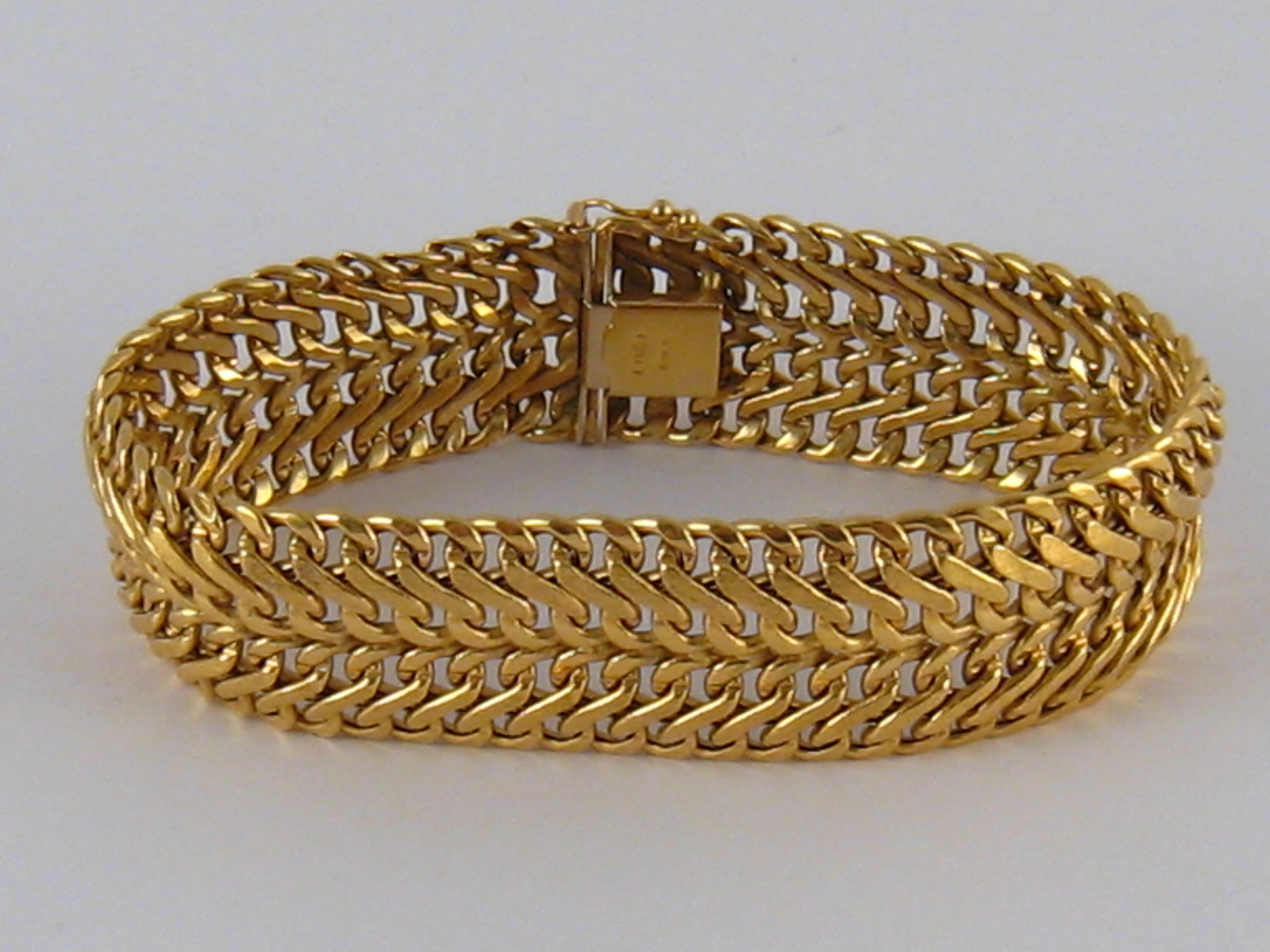 A yellow metal (tests 18 carat gold) bracelet, approx 19.5cm long, 2cm wide, 23.