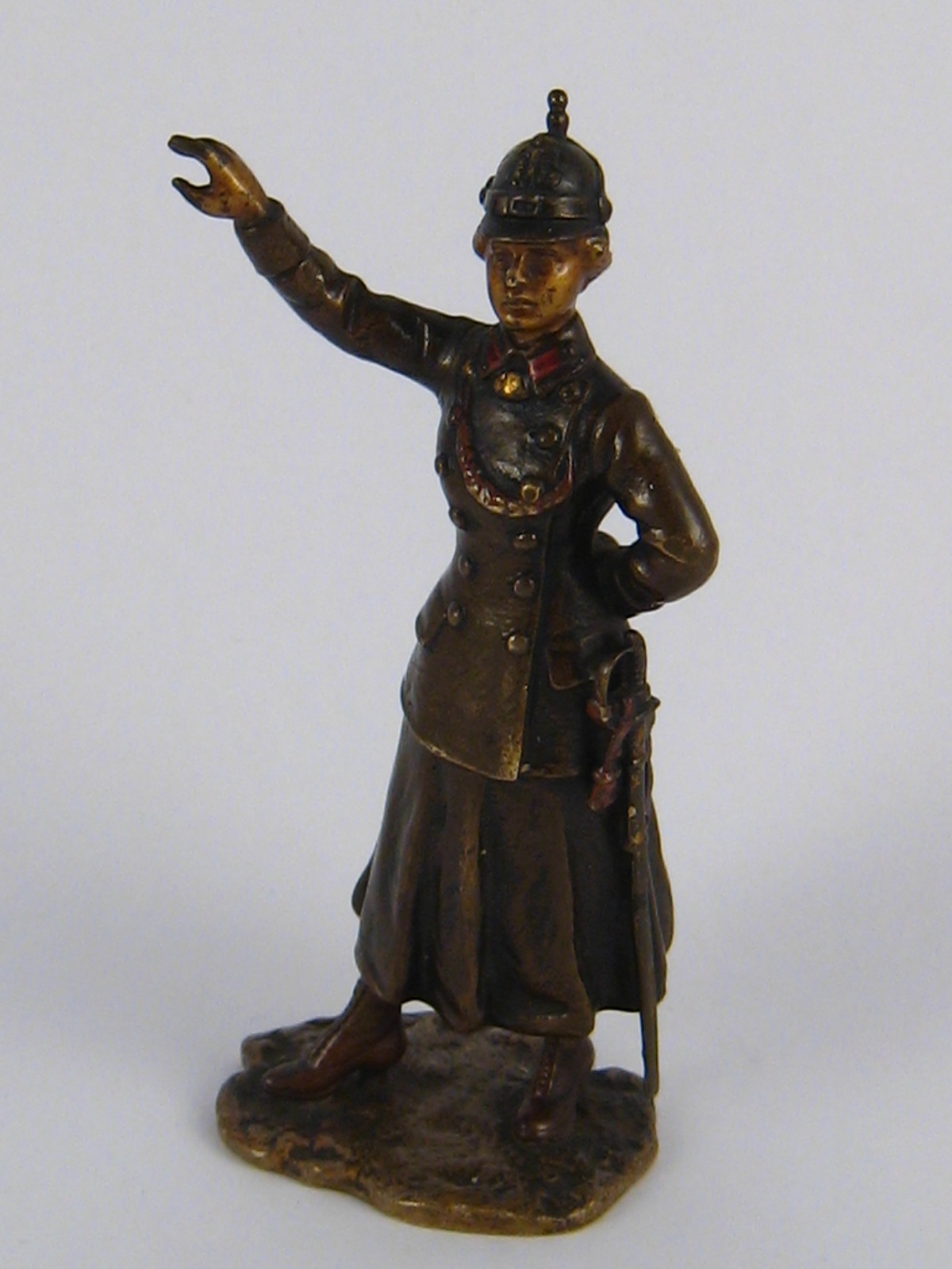 A cold painted Austrian bronze figure of a woman officer wearing a pickelhalb helmet,