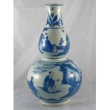 A 20th century double gourd shaped Chinese vase with landscape in blue and white. Ht.39cm. Repaired.