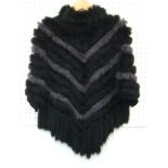 A black and grey Rabbit Fur poncho. Size small.