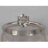 A white metal (tests 18 carat gold) diamond solitaire ring,