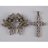 A mixed lot comprising a white metal (tests silver) diamante cross,