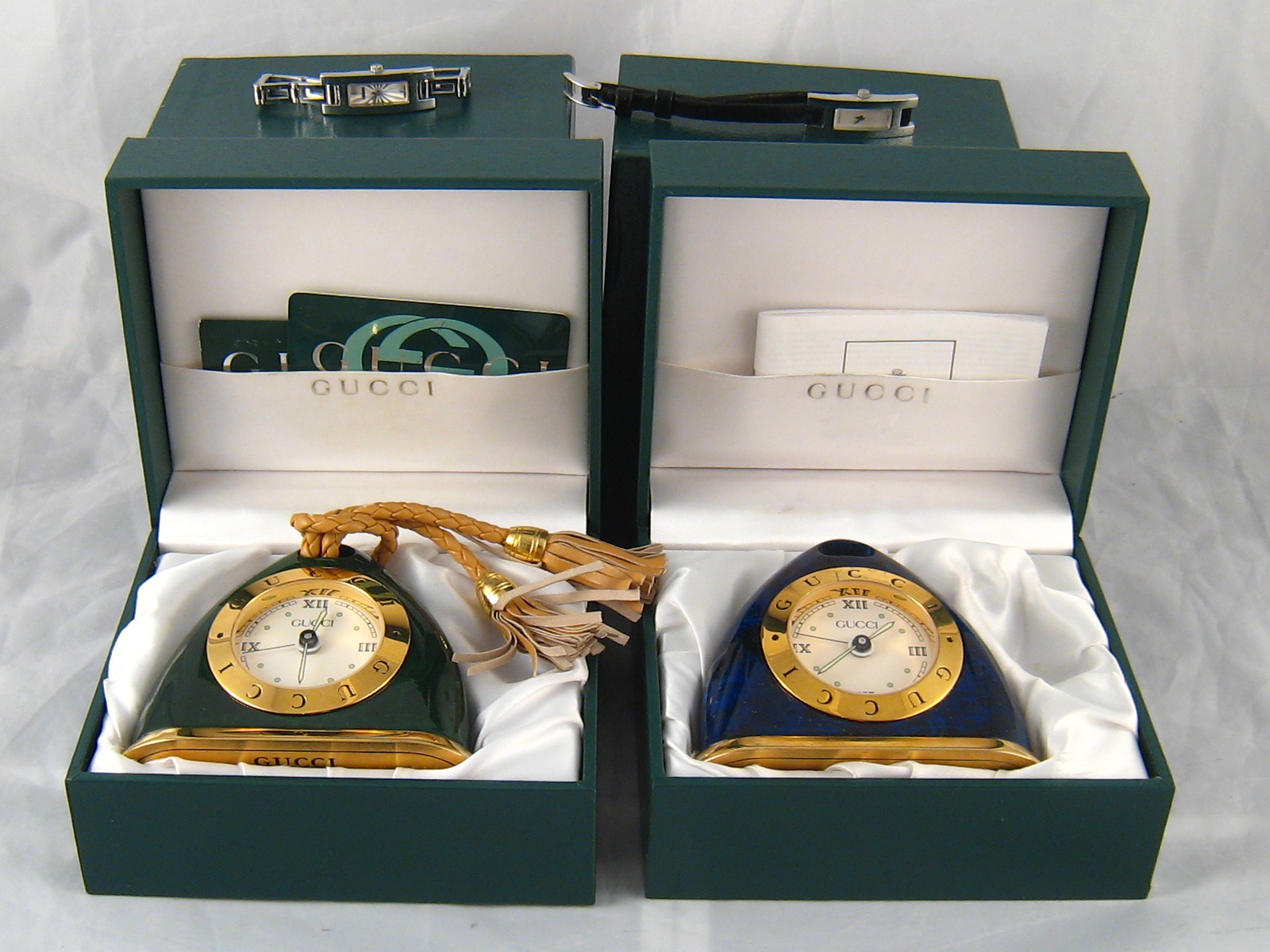 A mixed lot comprising a vintage lapis lazuli effect lacquer travel alarm clock by Gucci,