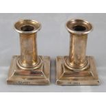 A pair of Victorian silver short column candlesticks on square bases, London 1883. Ht.9.5cm.