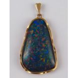 A yellow metal (tests 9 carat gold) opal doublet pendant, approx 4.5cm, 8.9 gms.