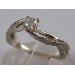 A white metal (tests 18 carat gold) diamond ring,