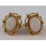 A pair of 9 carat gold opal ear studs, approx 1cm,