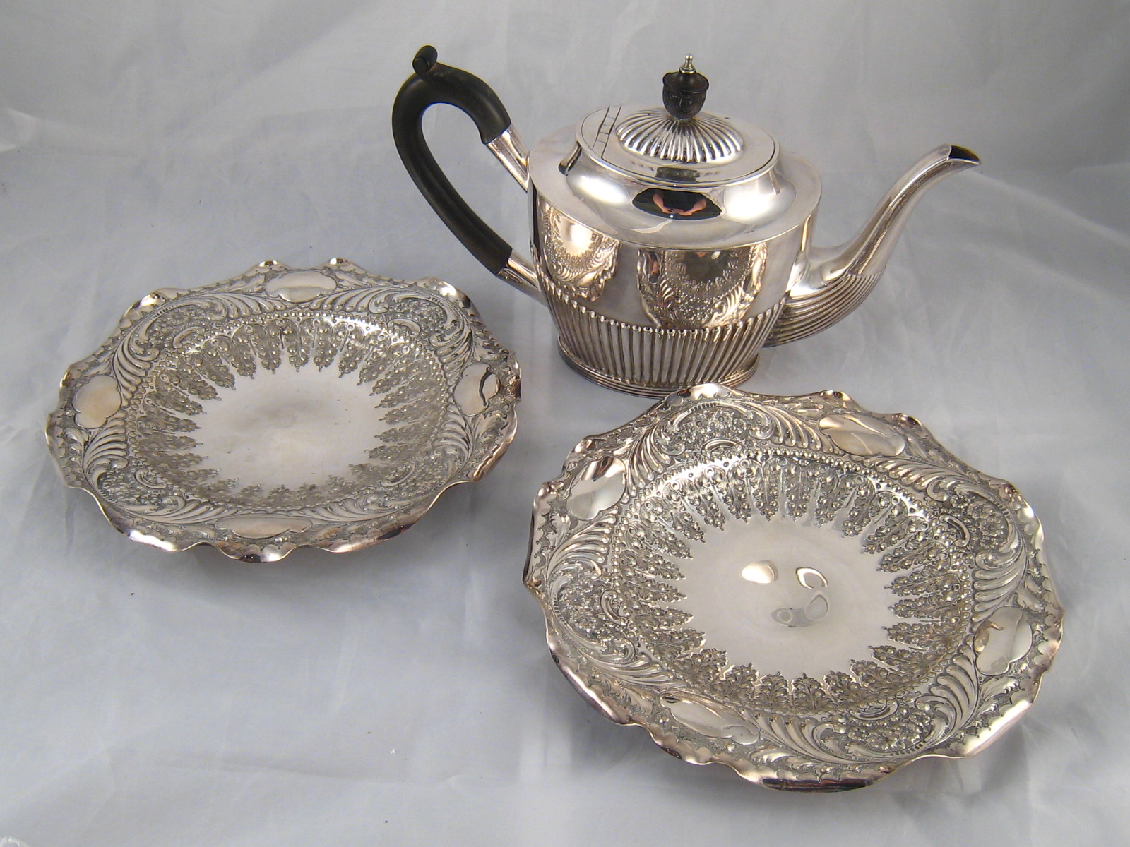 A pair of silver plated shaped and embossed dishes, 21cm.