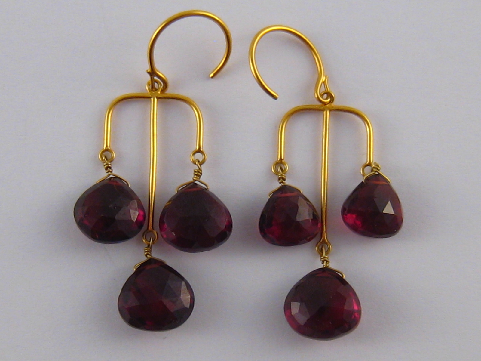 A pair of yellow metal (tests 18 carat gold) garnet earrings, drop approx 5cm, 8.1 gms.