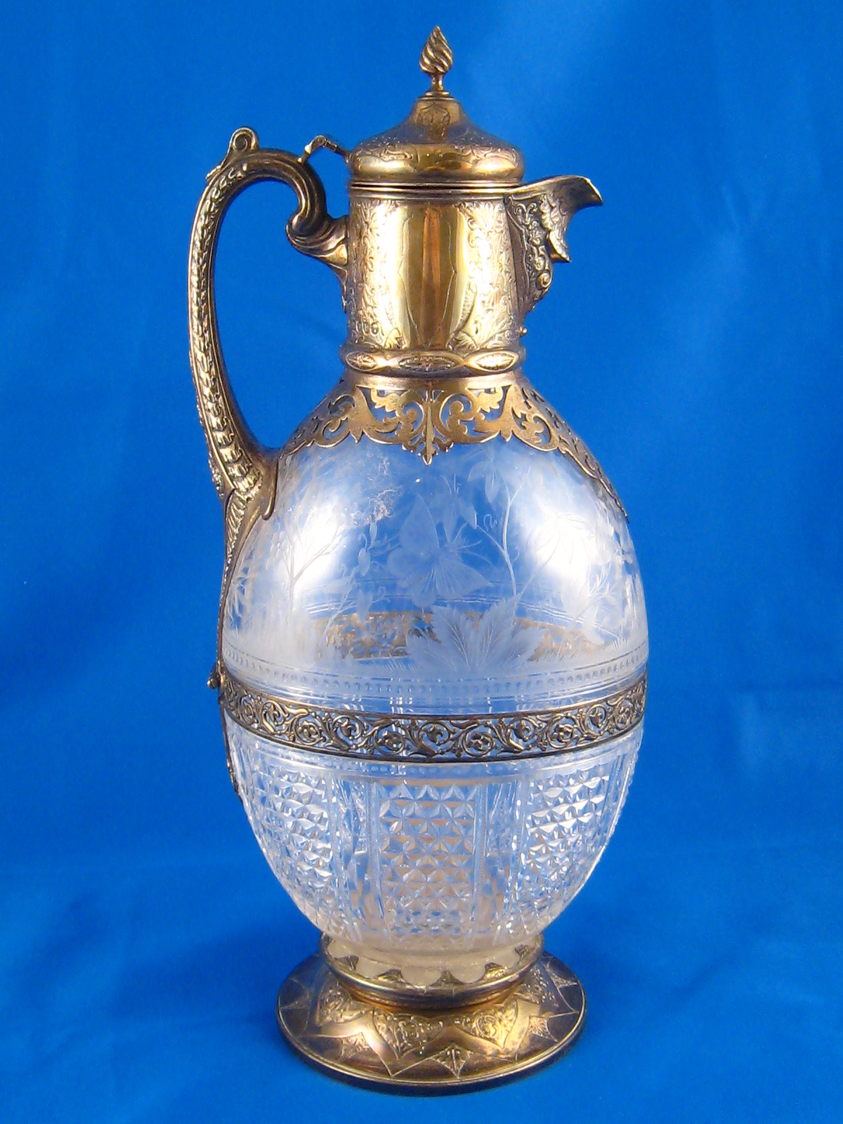 A Victorian silver mounted cut and engraved glass claret jug,