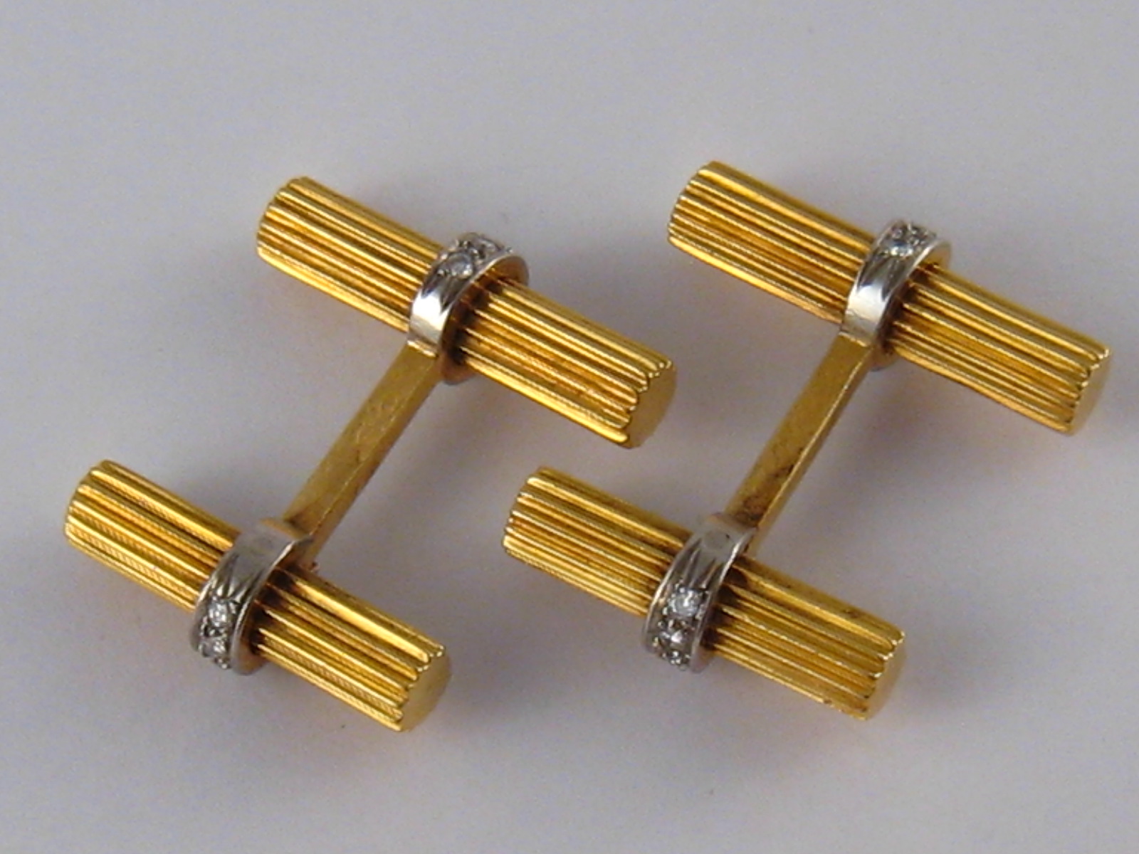 A pair of yellow metal (tests 18 carat gold) diamond cufflinks, numbered 119013, approx 2.5 x 2.