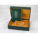 A fitted Rolex watch box with a certification booklet.