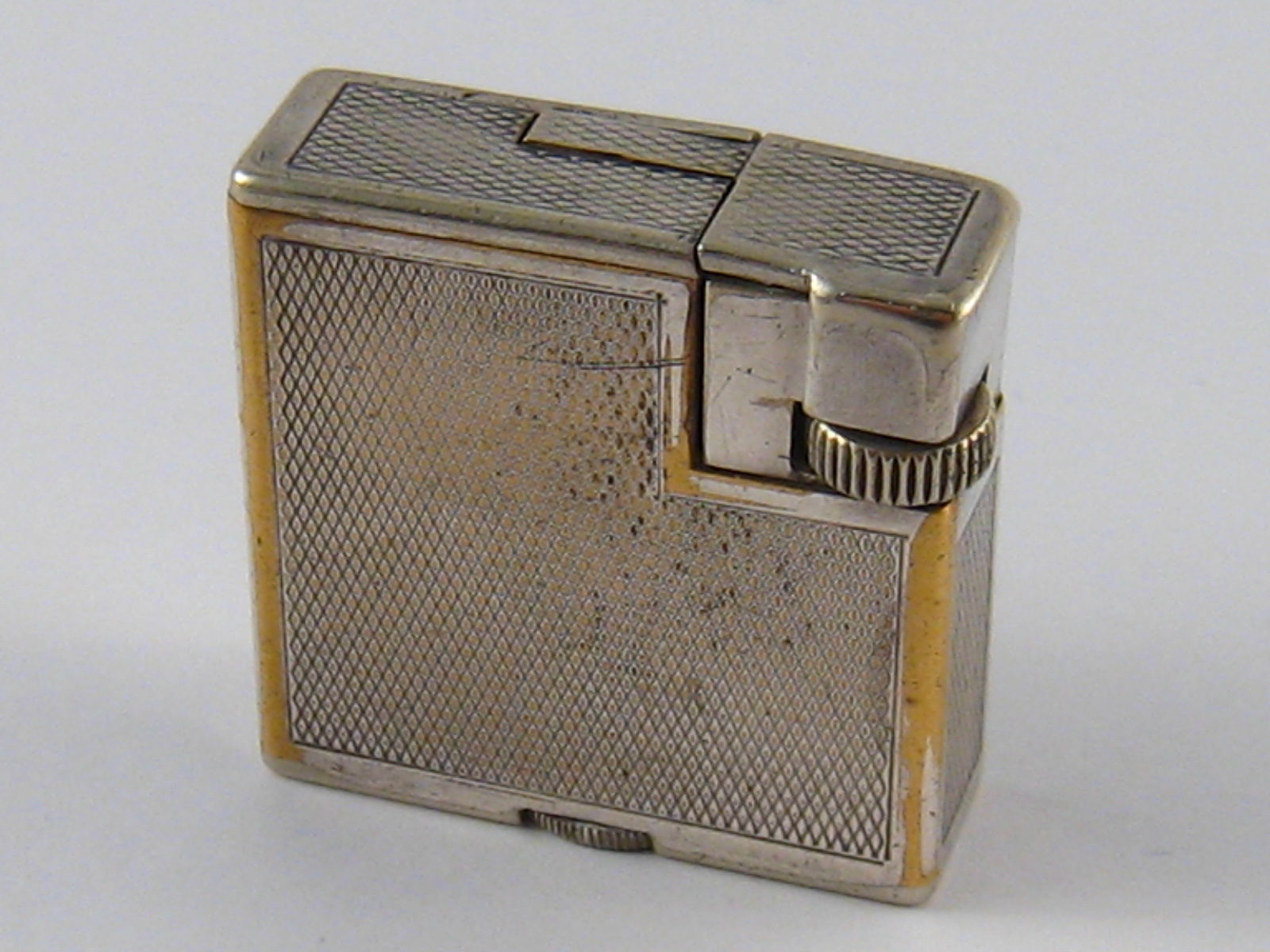 A silver plate Dunhill London cigarette lighter, made in Switzerland, approx 3.5 x 3.5cm.