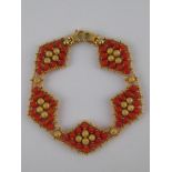 A yellow metal (tests 18 carat gold) coral bracelet, approx 19cm long, 2cm wide, 20.7 gms.