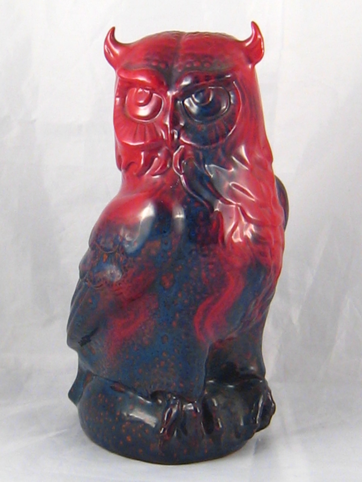A Doulton ceramic owl with mottled red flambe glaze,