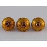 A set of three yellow metal (tests high carat gold) buttons, each approx 1.5cm wide, gross weight 5.