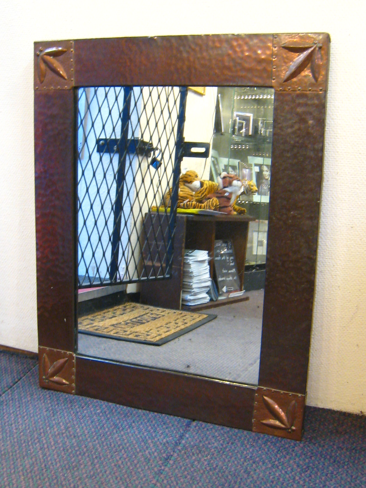 A copper framed Arts and Crafts mirror with hammered finish ,