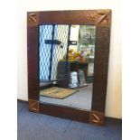 A copper framed Arts and Crafts mirror with hammered finish ,