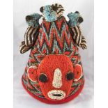 Tribal Art . A Yoruba beaded hat adorned with three birds, Nigeria. Ht. 33cm.