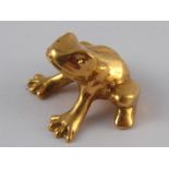 A yellow metal (tests 18 carat gold) model of a frog, approx 2cm wide, 16.5 gms.