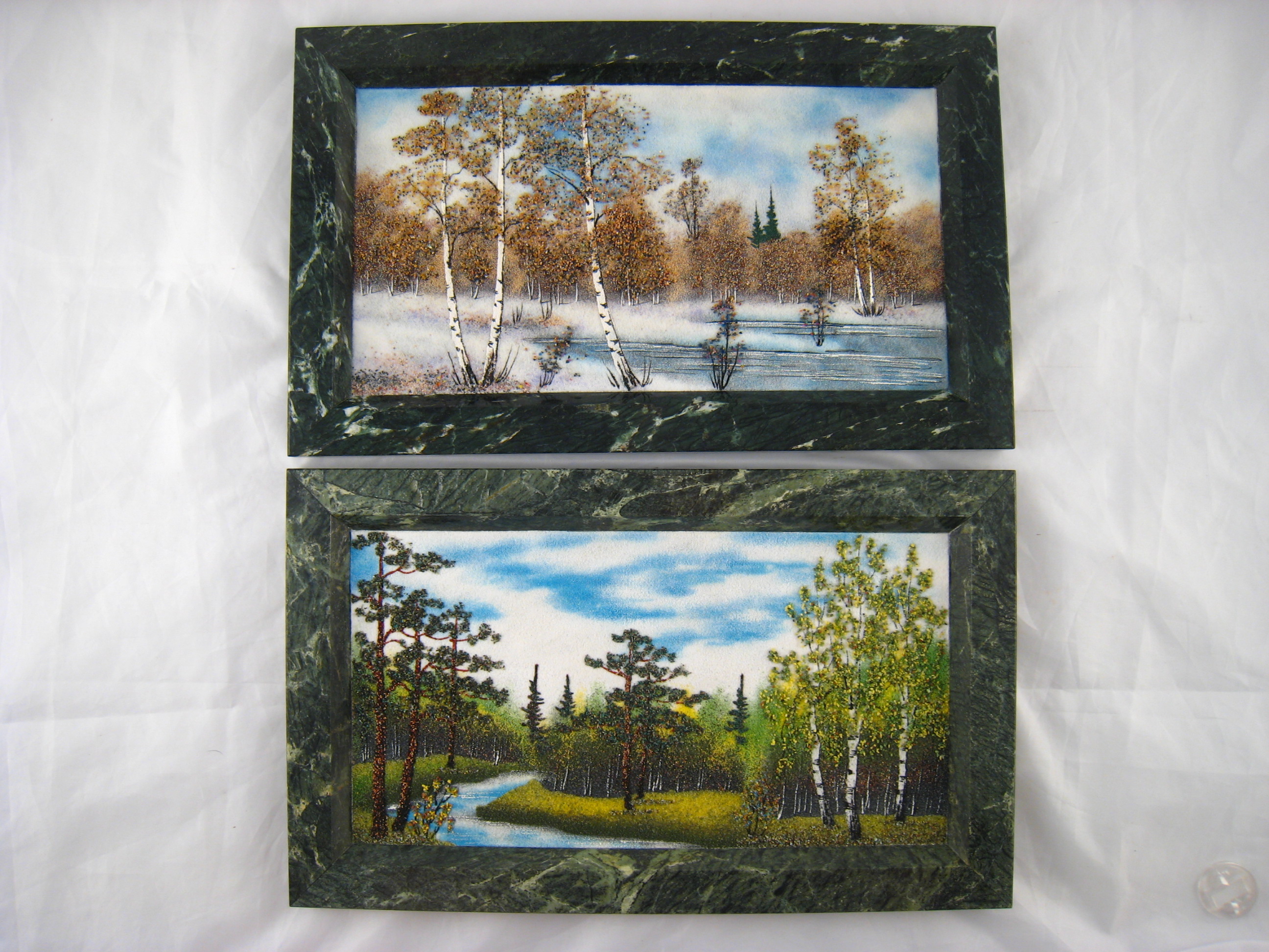 A pair of textured "sand"pictures on marble in green granite frames of northern forest landscapes