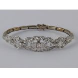 A white metal (tests 18 carat gold and platinum) diamond bracelet, numbered 648,