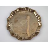 A small silver salver with Chippendale rim, Birmingham, circa 1914 (marks rubbed). 16cm. across, wt.