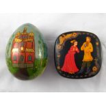 A Russian turned and painted wooden Easter egg dated 1999, ht. 11.5cm.