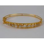 A yellow metal (tests 18 carat gold) rose cut diamond bangle, internal width approx 5.