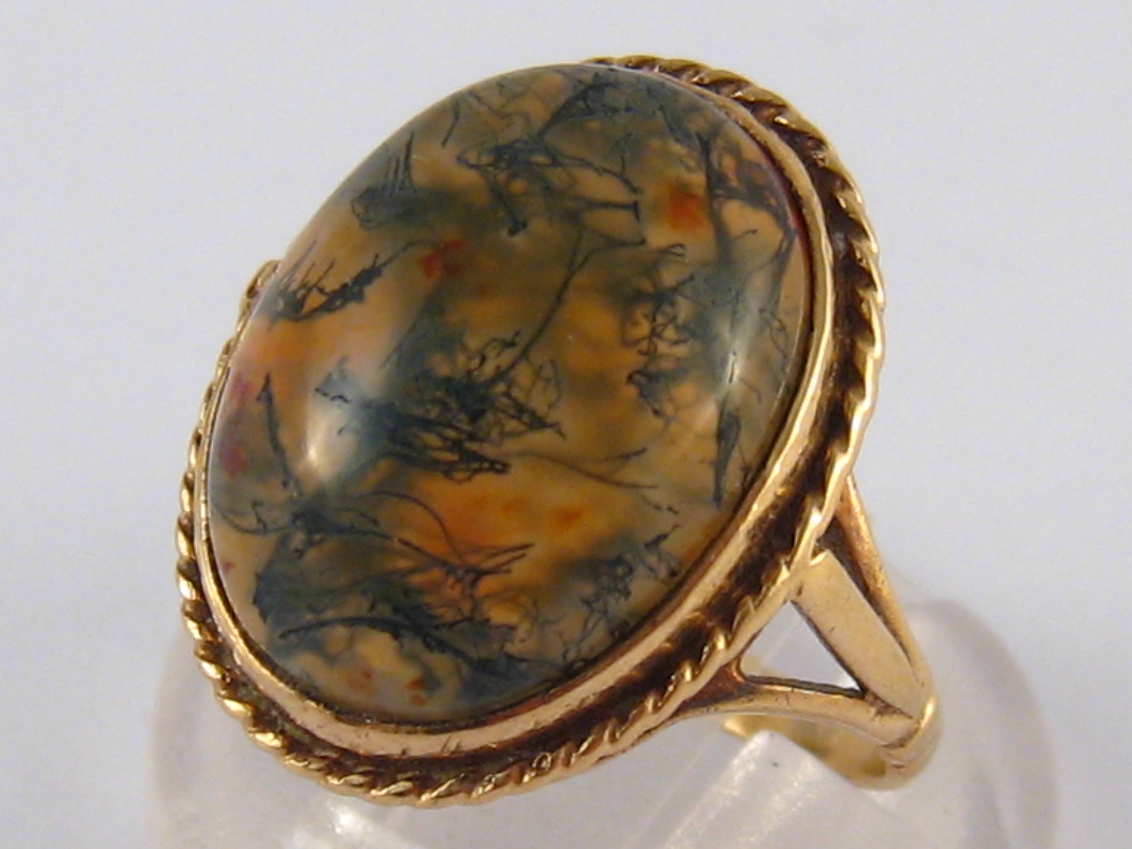 A 9 carat gold moss agate ring, agate approx 16 x 12.5mm, ring size J, 4.2 gms.