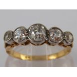 An 18 carat gold five stone old brilliant cut diamond ring, the largest stone measuring approx 4.