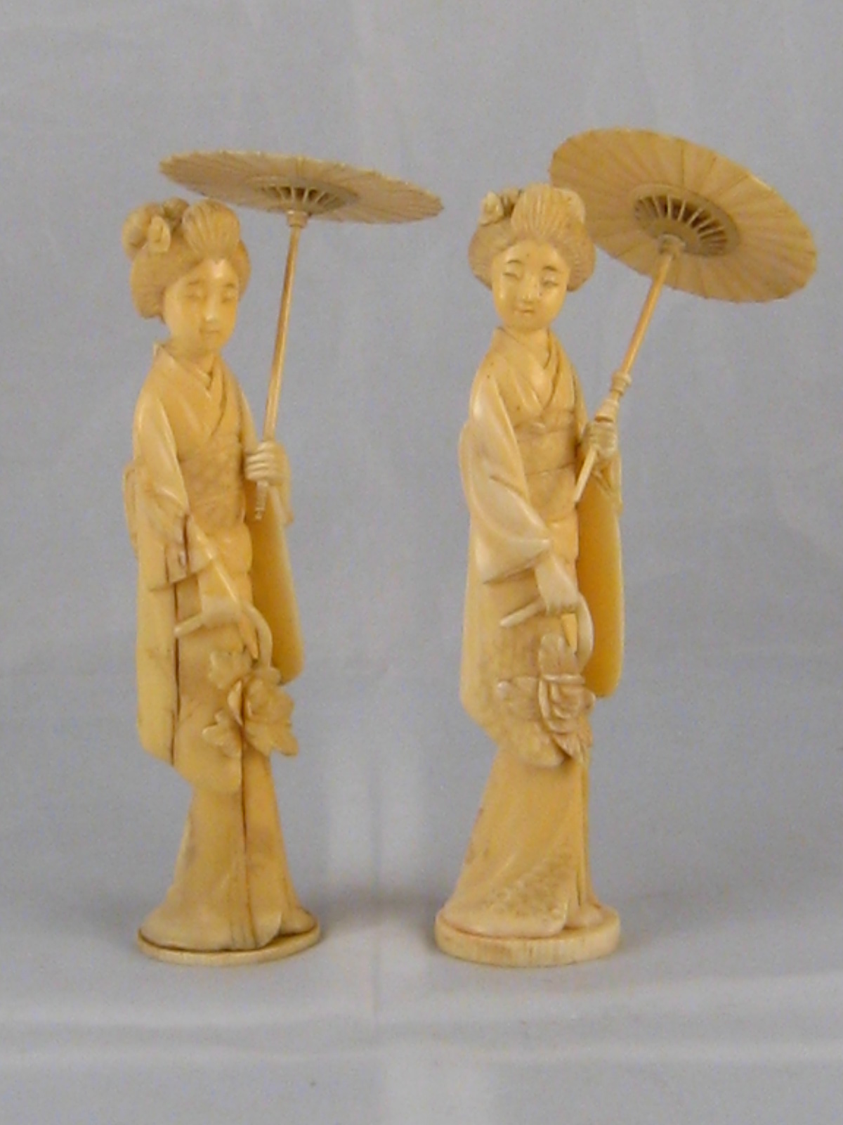 Two Japanese ivory figures, each a lady with parasol , circa 1920, in original wooden boxes. Ht.