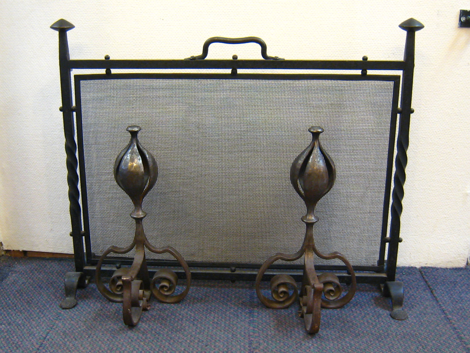 A pair of heavy wrought iron Arts & Crafts firedogs and firescreen. Firedogs ht. 40cm.