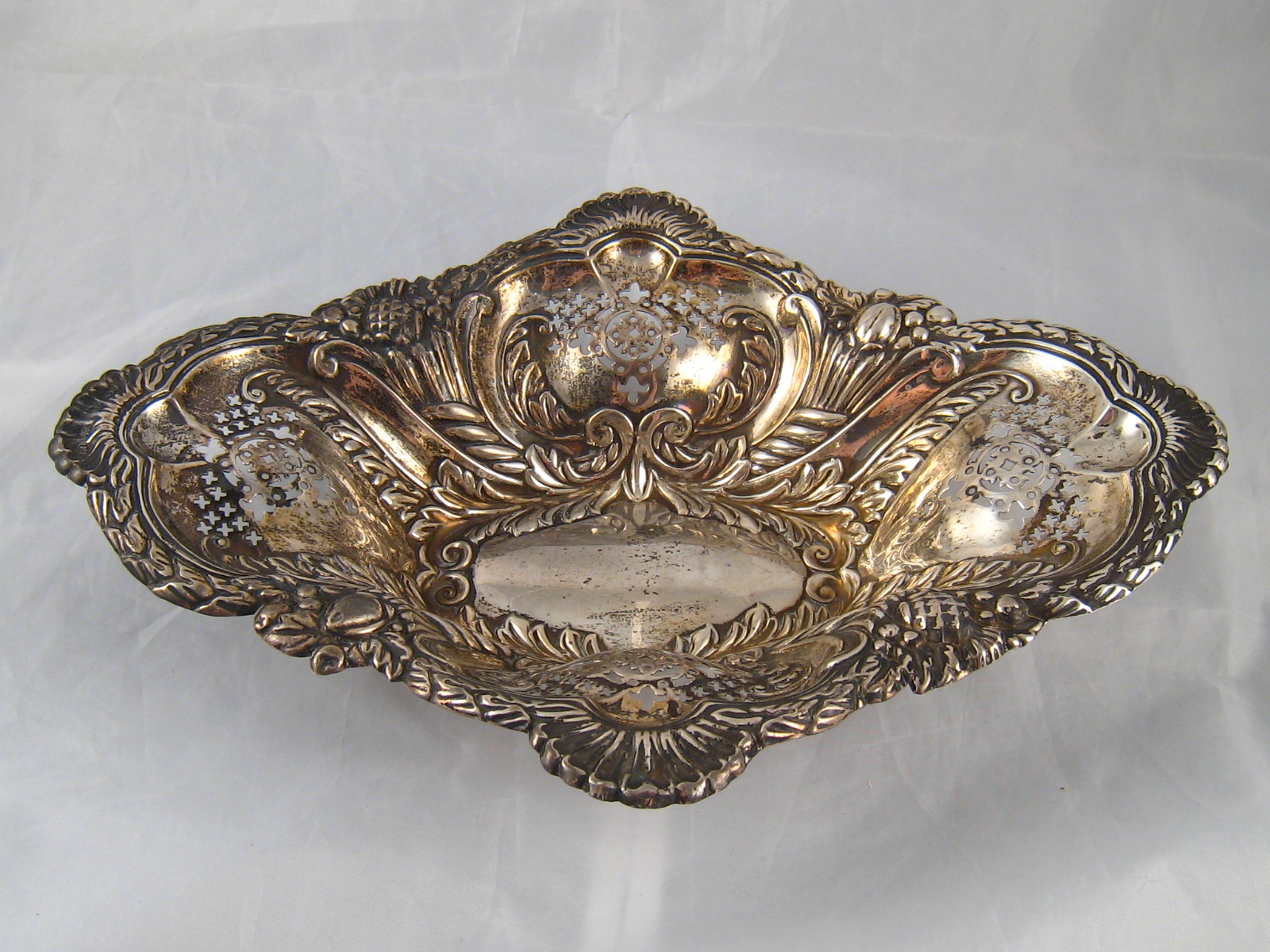 A shaped deep oval pierced and embossed late Victorian silver dish by Elkington & Co.