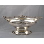 A large silver shaped oval bowl centrepiece on stand with cast scroll,