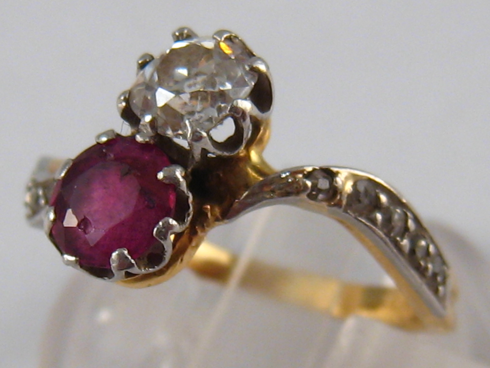 A yellow metal (tests 18 carat gold) diamond and ruby ring,