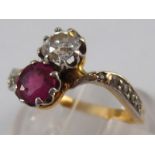A yellow metal (tests 18 carat gold) diamond and ruby ring,