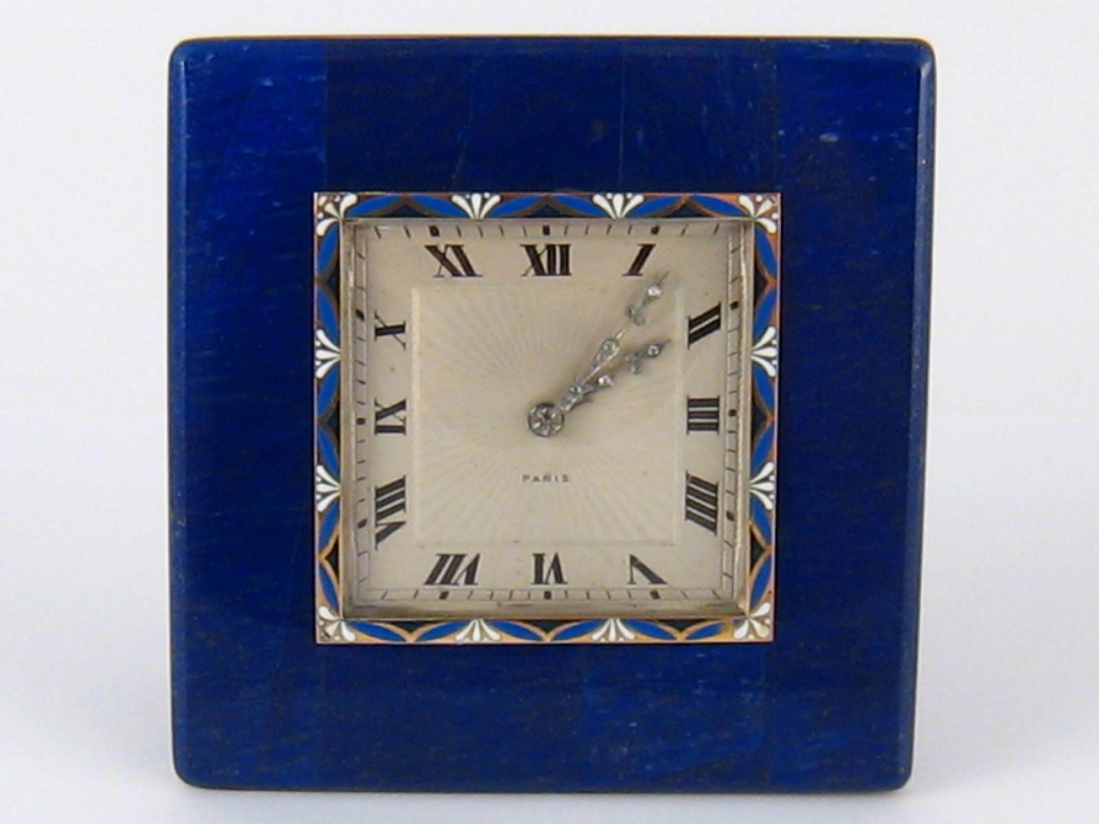 A French hallmarked silver and lapis lazuli clock, with gold, silver and enamel bezel and diamond