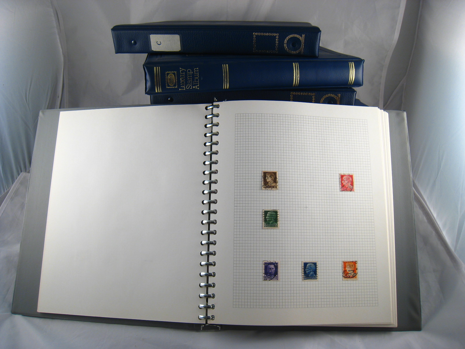 A set of twenty one matching Multo- Ring stamp albums containing an assortment of postage stamps of