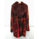 A fox fur and red leather 3/4 length medium sized coat.