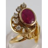 A yellow metal (tests 14 carat gold) ruby and diamond ring, the ruby measuring approx 8.5 x 6.